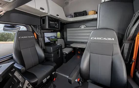Sleeper cab interior with bunk and fridge
